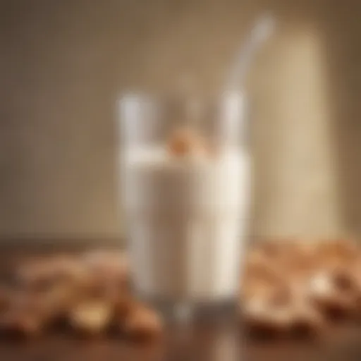 A glass of cashew milk surrounded by cashews and almonds.