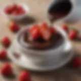 Rich and glossy chocolate sauce in a small bowl with strawberries