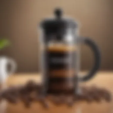 A French press positioned beside freshly ground coffee beans.