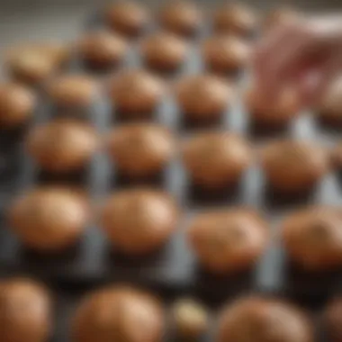 Effortless Placement of Paper Muffin Cups A hand placing a paper muffin cup into a baking tray, illustrating ease of use