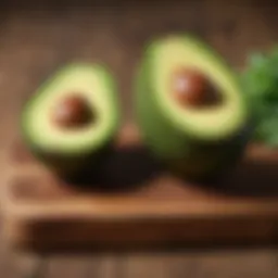 Half an avocado with vibrant green flesh and a dark pit showcased on a wooden board.