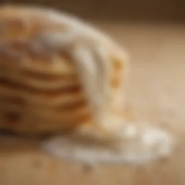 A close-up of flour spilling from a bag, symbolizing the foundation of pancake batter.