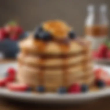 A stack of fluffy pancakes drizzled with cinnamon maple syrup, garnished with fresh berries.