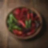 A vibrant selection of various chiles displayed on a rustic wooden table