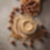 A jar of creamy hazelnut spread with a spoon resting beside it, surrounded by whole hazelnuts.