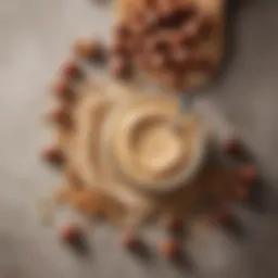 A jar of creamy hazelnut spread with a spoon resting beside it, surrounded by whole hazelnuts.