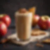 A vibrant apple pie smoothie in a glass garnished with cinnamon