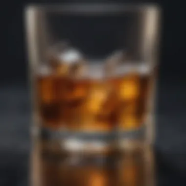 A close-up of a polished rocks glass with ice cubes and whiskey.