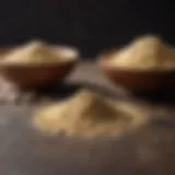 A close-up comparison of ground garlic and garlic powder in small bowls.