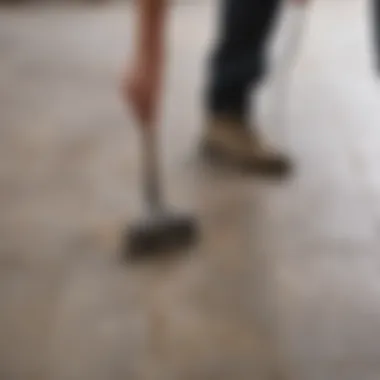 Person scrubbing grout with a brush and cleaning solution