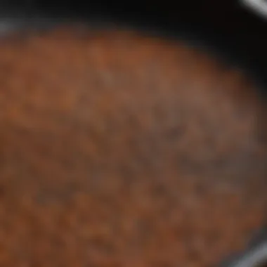 A close-up of the seasoning on a cast iron skillet, highlighting its texture