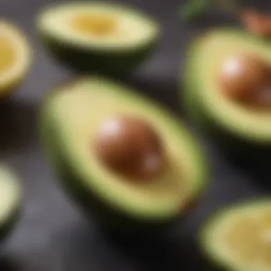 A cut avocado half with visible flesh and a lemon beside it to prevent browning.