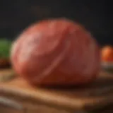 A perfectly glazed spiral ham resting on a wooden cutting board