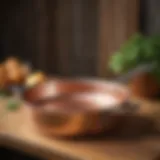 Elegant Mauviel copper saute pan on a wooden table