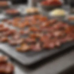 A clean and organized kitchen countertop with bacon strips ready for frying.