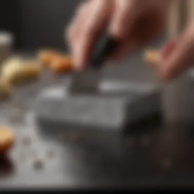 A close-up view of a sharpening stone being used on a kitchen knife.