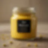 A close-up of a jar of English mustard showcasing its texture and color.