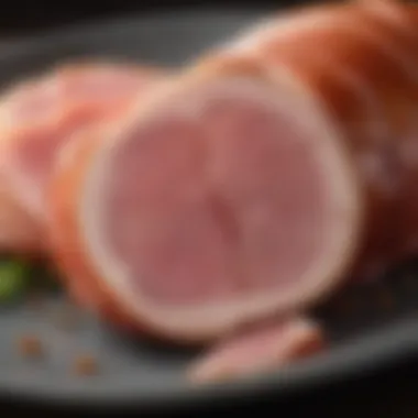 Juicy Texture of Vermont Spiral Sliced Ham Close-up of Vermont spiral sliced ham showcasing its juicy texture and marbling.